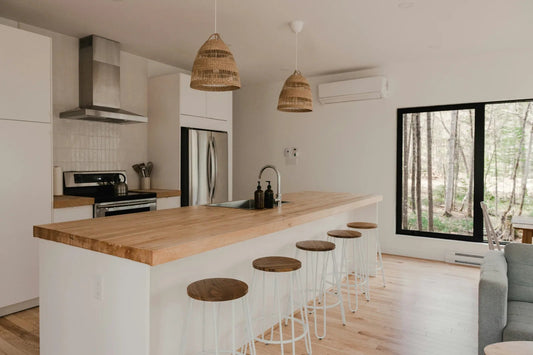 18,000 BTU mini-split on the wall of a bright open-concept kitchen with island seating