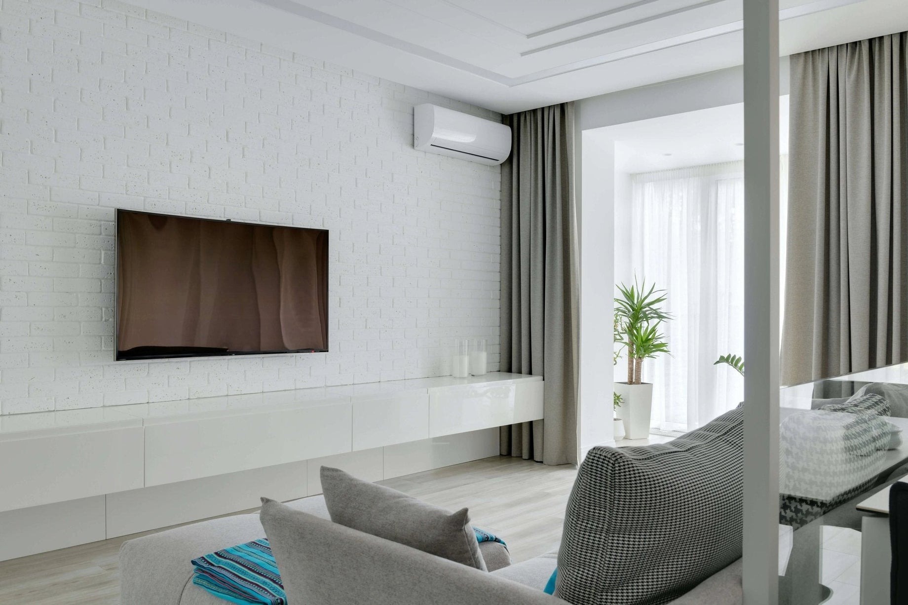 Wall-mounted ductless mini-split in a modern living room, illustrating the cost to run a mini-split per month